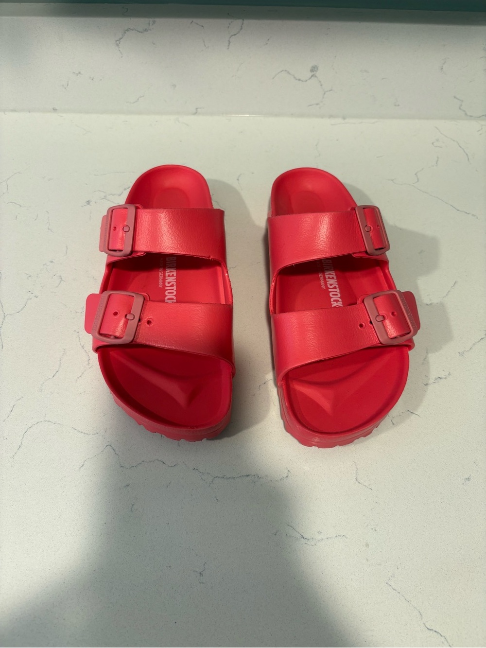 woman’s hot pink Birkenstocks